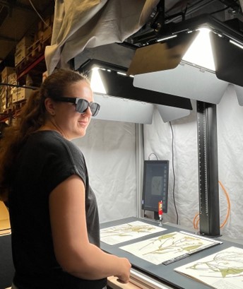 Digitiser with sunglasses at the digitising machine